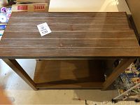 Top view of wooden sofa table showing slatted design and wood grain texture.