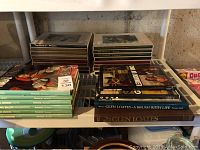 Shelf view showing stacks of various titled hardcover art books including The World of Picasso, Turner, and Cassatt.