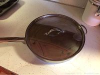 Martha Stewart Everyday 12-inch saute pan with glass lid, stainless steel, like new condition under light