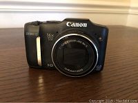 Front view of Canon PowerShot SX160 IS digital camera showing 16x optical zoom lens and branding.