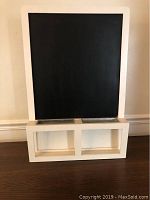 Framed chalkboard with black surface and white frame, showing overall size and shape