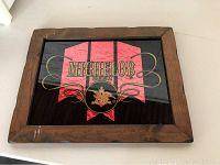 Front view of vintage Michelob beer sign with wood frame and intact glass showing red and gold design.