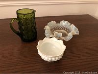 Set showing green hobnail pitcher, blue ruffled hobnail dish, and white hobnail fairy lamp base on wooden surface