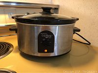 West Bend Crockpot slow cooker placed on kitchen counter, showing overall appliance body from side angle