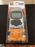 Front view of the Dymo Personal Labelmaker LT-100H in original sealed packaging highlighting the large display and buttons on the device.