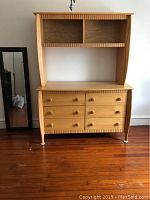 Full view of the dresser with attached removable hutch showing overall condition and design, placed on hardwood floor.