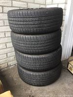Four stacked tires showing tread and sidewall shape.