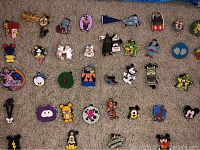 Close-up of 41 colorful Disney pins including Mickey Mouse, Minnie Mouse, Donald Duck, Goofy, Chip and Dale, and other character themed pins