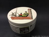 View of the covered bowl top with Santa Claus, green sleigh and reindeer illustration on chimney roof.