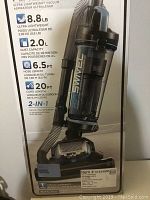 Box front showing Black & Decker AirSwivel Lite vacuum cleaner image, brand, model BDASL102C, product features including weight 8.8 lb, dust capacity 2.0L, hose length 6.5 ft, cord length 20 ft, 2-in-1 crevice tool with brush.