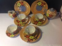 All items in the 15 piece vintage Japan tea set, displaying cups, saucers, creamer, sugar bowl, teapot, and salad plates