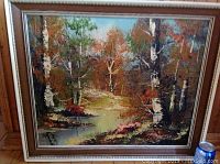 Frontal view of the large framed oil painting showing autumn forest landscape with a river and birch trees.