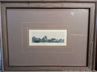 Framed silkscreen landscape art print in a brown wood frame with glass, matted with beige double mat.