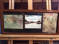 Framed set of three abstract paintings by Charlie McKenzie, overview of entire frame and arrangement.