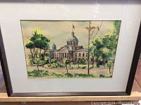 Framed hand colored print showing the Frontenac County Courthouse with trees and flagpole.