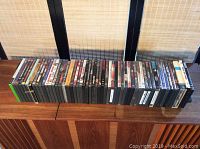 Front row of DVD cases aligned next to each other, showing a range of movie titles mostly from drama and thriller genres.