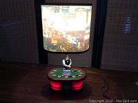 Full view of the table lamp showing the poker table base with dealer figurine and illuminated Las Vegas cityscape lampshade.