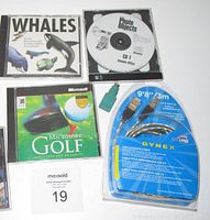 Overall view of all items in the lot including new sealed Dynex USB cable, green USB port connector, and three CD-ROMs: Whales, Microsoft Golf, and Photo Objects.