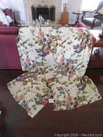 Silk duvet cover draped over furniture showing its floral pattern in a living room environment.