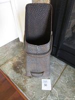 Front view of the vintage hammered metal coal scuttle showing the angled top opening and overall hammered texture