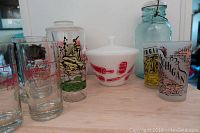 Showing the various glasses, the white cookie jar, Fire King mixing bowl with lid, and blue mason jar