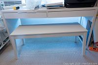 White IKEA Micke desk with two drawers and a lower shelf, showing clean condition and modern design