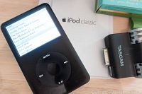 Apple iPod Classic 80GB screen displaying music menu, partial view of Tascam IM2 microphone