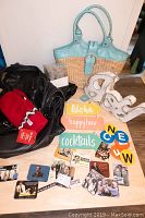Three handbags including vintage Browns basket-weave purse and two black leather Banana Republic purses, red Tim Horton's mittens with tags, various fridge magnets, wooden decorative signs with bright text, and string lights.