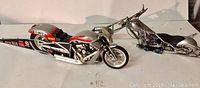 Two detailed precision metal motorcycle models on white background showcasing front and side angles.