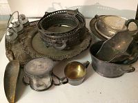 Overview of eleven vintage silverplate items showing various trays, small pitchers, covered dish, shakers, ladle, and scoop.