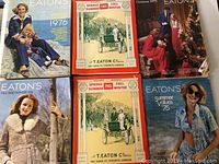 Full view of six Eaton's catalogues including four vintage 1975-1976 editions and two 1901 reproduction catalogues.