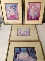 Photo showing all four Botero framed prints laid out on table