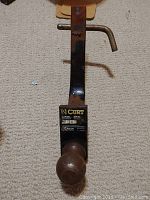 Full view of the Curt trailer hitch with ball attached, showing the metal bar and hitch pin.