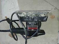 Photo of Craftsman electric pad sander showing sanding plate, handle, power cord, and brand label.