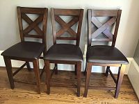 Three chairs front view showing X-back design and seat cushions