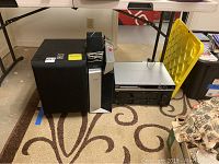 Yamaha stereo receiver with Philips DVD player on the floor next to speakers and subwoofer