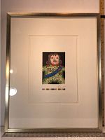 Frontal view of framed lithograph showing white mat and silver-tone frame