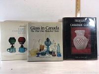 Front view of all three books together showing their covers with images of glassware.