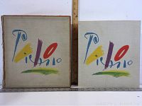 Photo showing the Picasso limited edition book and the clamp-shell box, both with canvas covers and colorful Picasso signature artwork, with measuring rulers showing dimensions about 11 inches tall/broad.