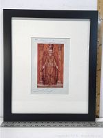 Framed offset lithograph showing full artwork with ruler for scale