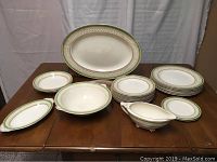 Photo displaying the full assortment of plates, vegetable bowl, gravy boat with undertray, and large oval platter in J & G Meakin Sol Westminster green band pattern.