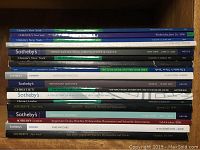 View of the watch auction catalogues stacked showing titles from Sotheby's and Christie's, dated between 1996 and 2008.