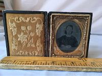 Front view of antique framed lady photo in hinged case, showing intact case and velvet interior with ruler for scale.