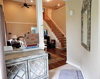 View of the credenza positioned in room, showing its height, shape and finish