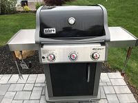 Front view of Weber Spirit E-310 grill with side shelves and control panel