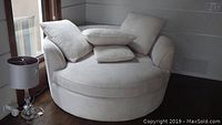 Front view of circular lounge chair with four pillows