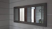 Full front view of mirror mounted on wall reflecting interior room