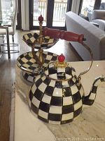 Full view of kettle and two-tier server on countertop showing checker pattern