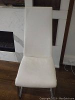 Front view of a single chair showing padded seat and tall back