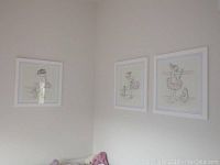 Three framed prints on wall showing ballerinas in tutus drawn in line art style with pink accents.